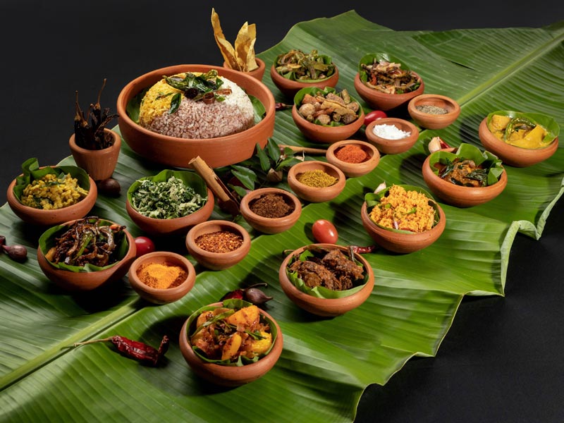 Traditional Sri Lankan Rice and Curry served on a Banana Leaf and in Clay pots